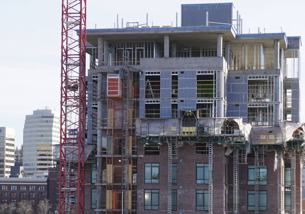 Spokane Falls Tower under construction with brick exterior and upper floors nearing completion in downtown Spokane.